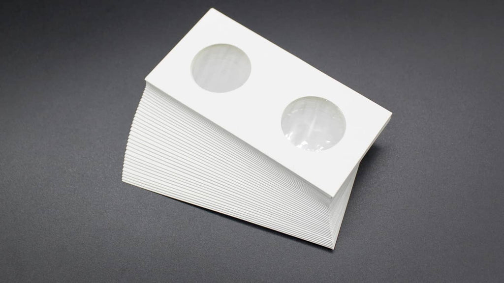 Stacked white coin flips with two oval coin openings on top card