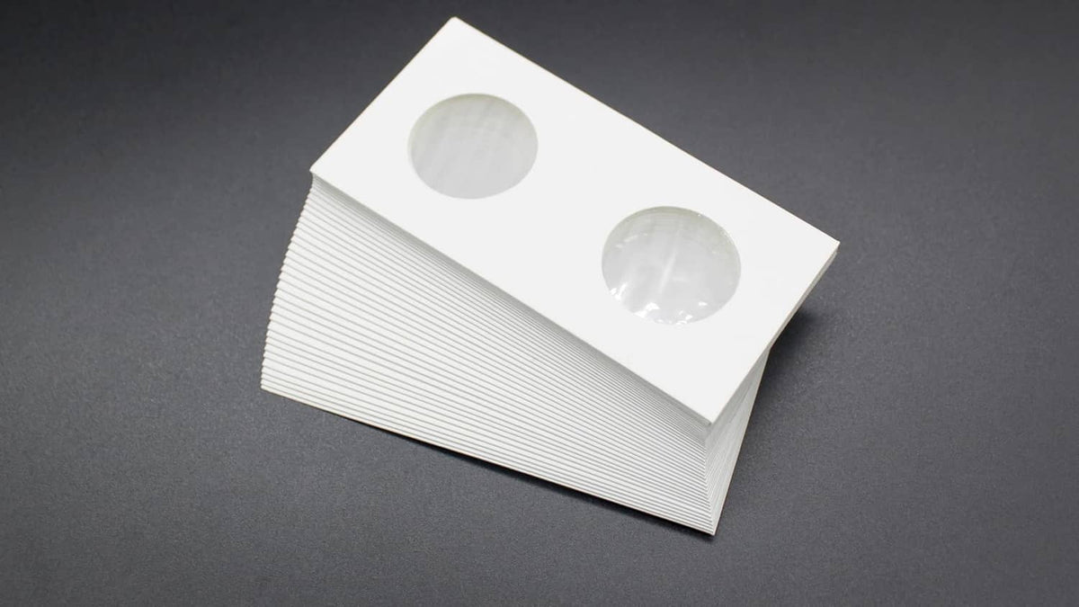 Stacked white coin flips with two oval coin openings on top card