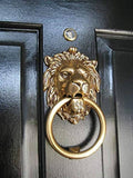 Brass lion door knocker with circular ring handle and detailed lion face mount