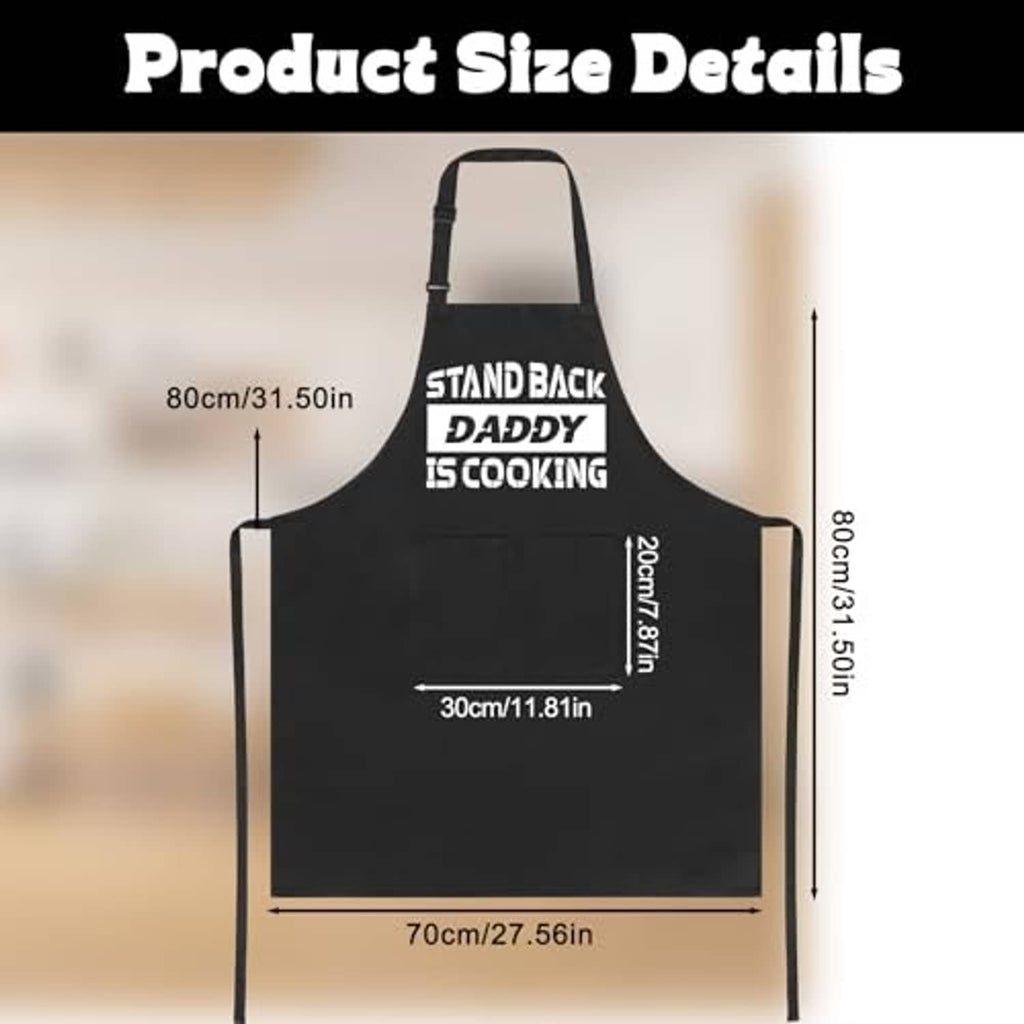 Black apron size diagram with straps; “STAND BACK DADDY IS COOKING” slogan print