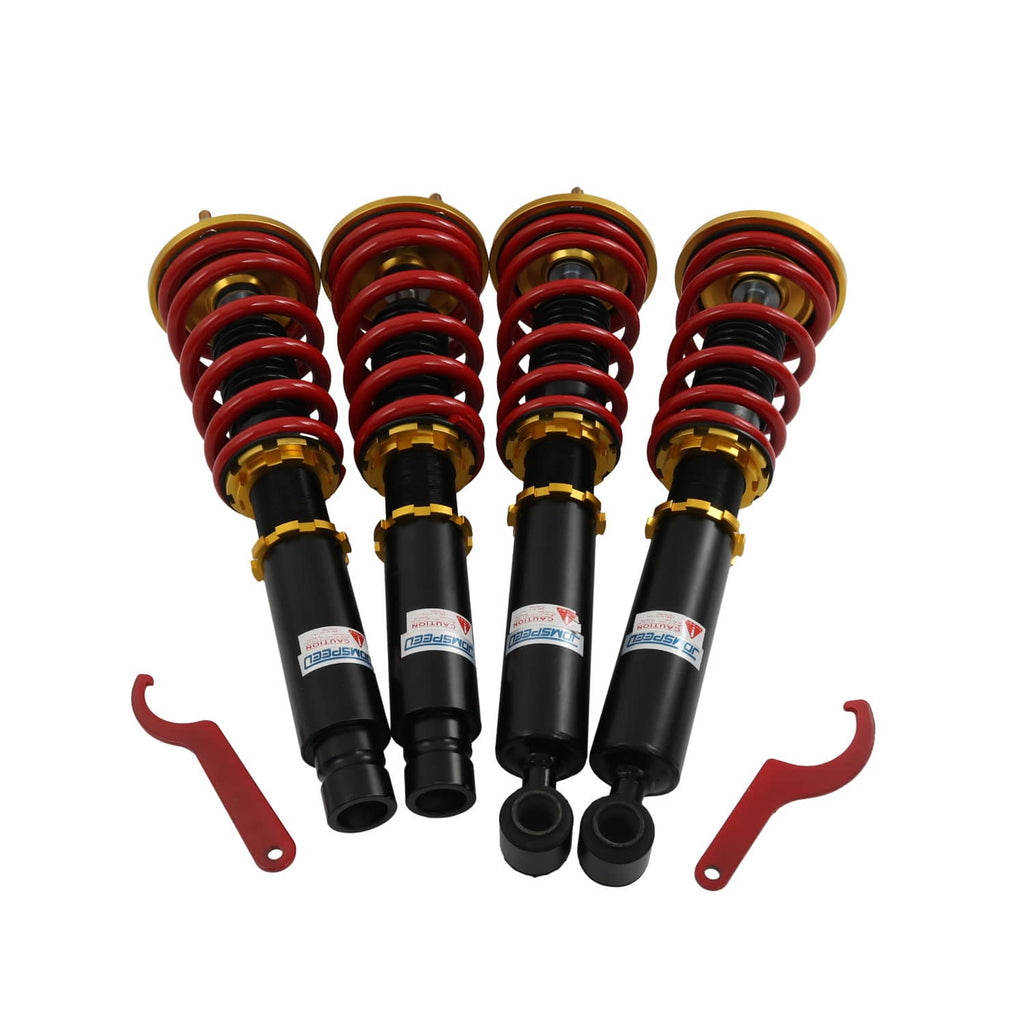 Coilover shock suspension set of four with red springs, black dampers, and gold adjusters