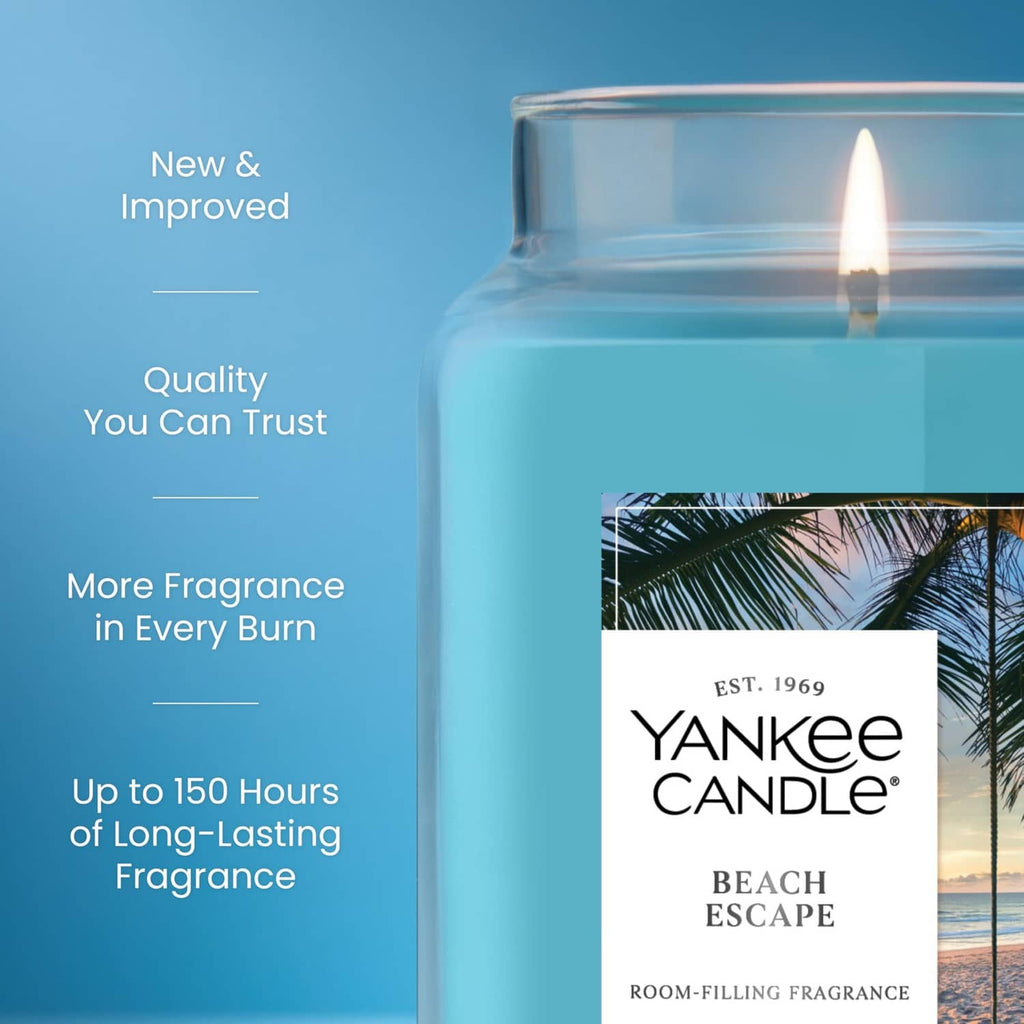 Scented jar candle with lit wick and Beach Escape label on blue jar
