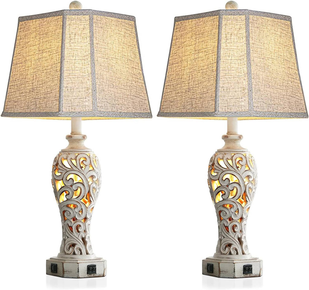 Set of 2 rustic table lamps with beige linen shades and carved white bases, front view