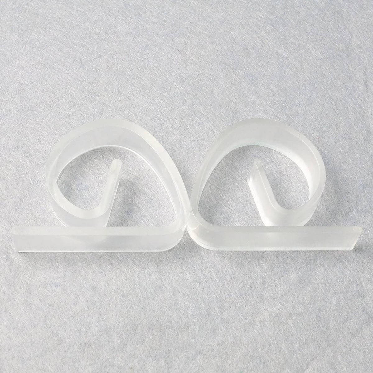 Pair of clear plastic tablecloth clips with flat base bar