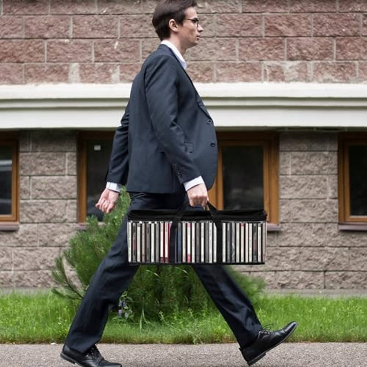 Clear PVC DVD storage bags with black handles, carried together in a bundle