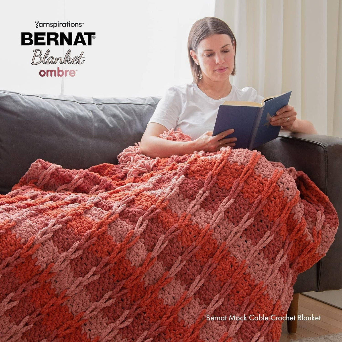 Chunky crochet blanket in red-orange ombre with raised stitch rows