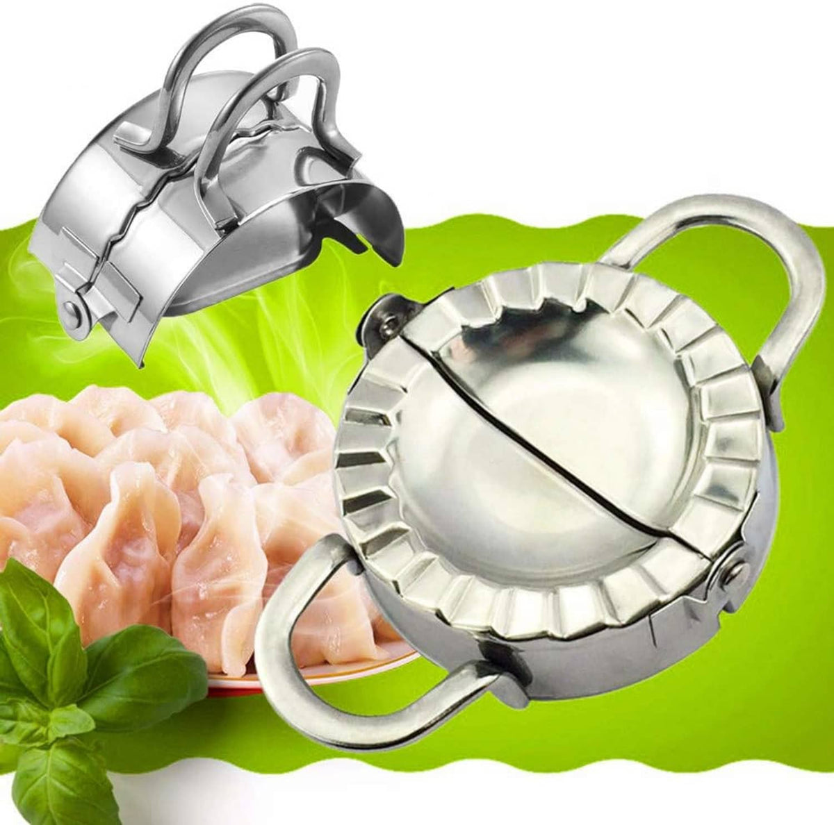 Stainless steel dumpling press with handles on green surface beside raw dumplings