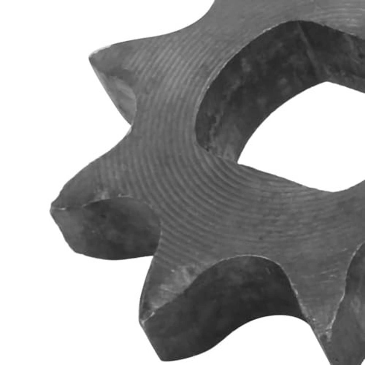 Close-up of dark 9-tooth sprocket teeth texture around the central opening