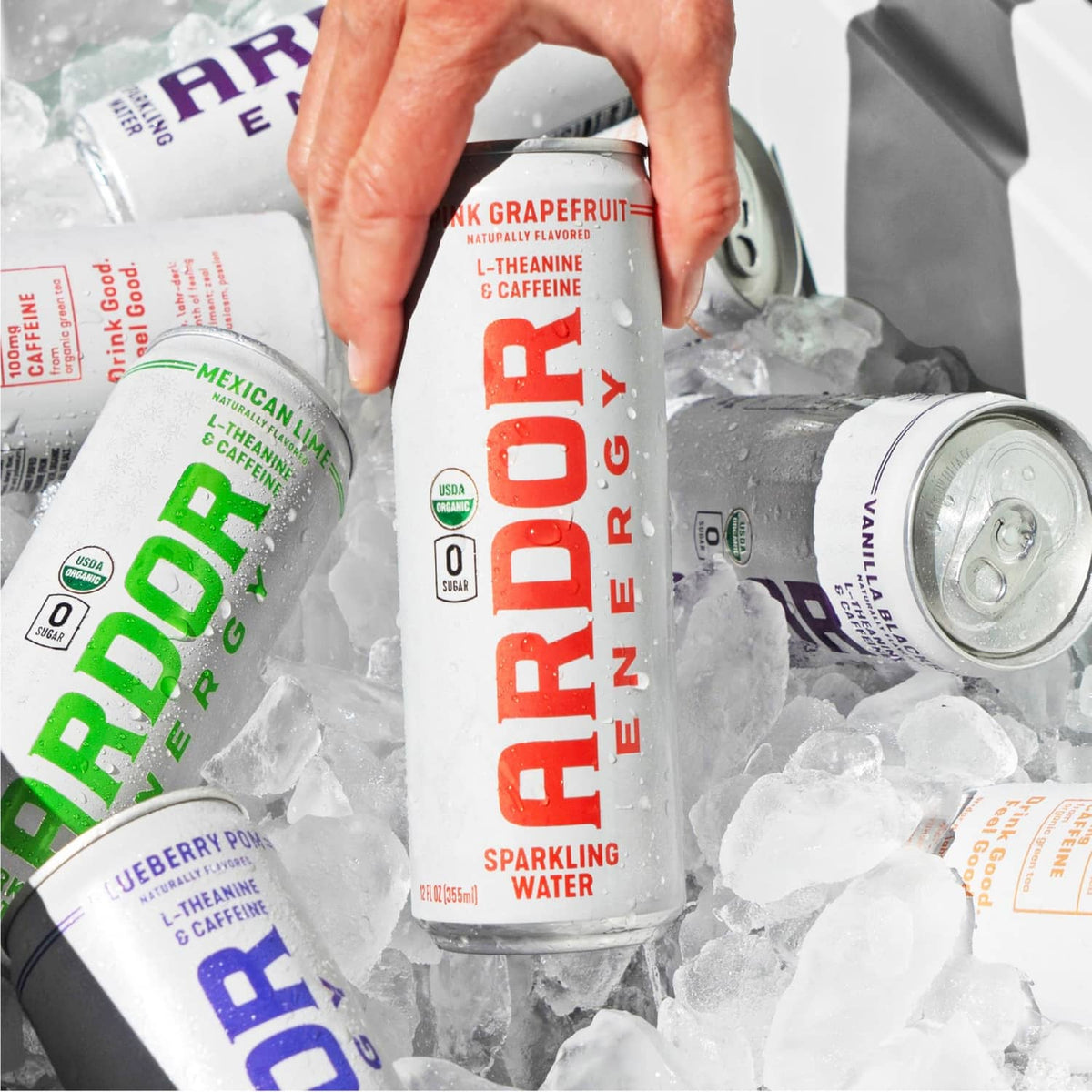 Sparkling water energy drink cans with ice, shown with an opened can