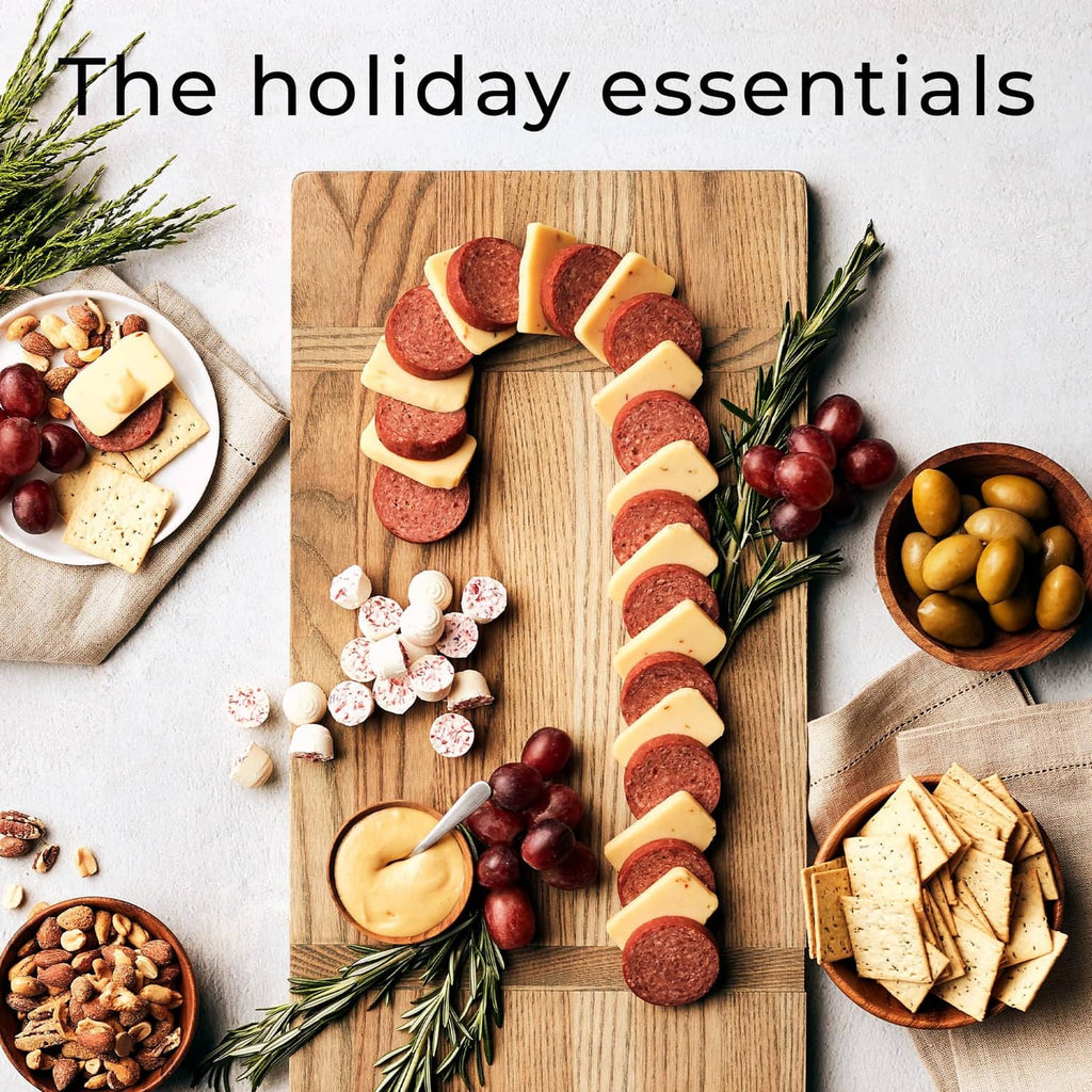 Beef Summer Sausage slices on a wooden board with crackers, cheese, and grapes