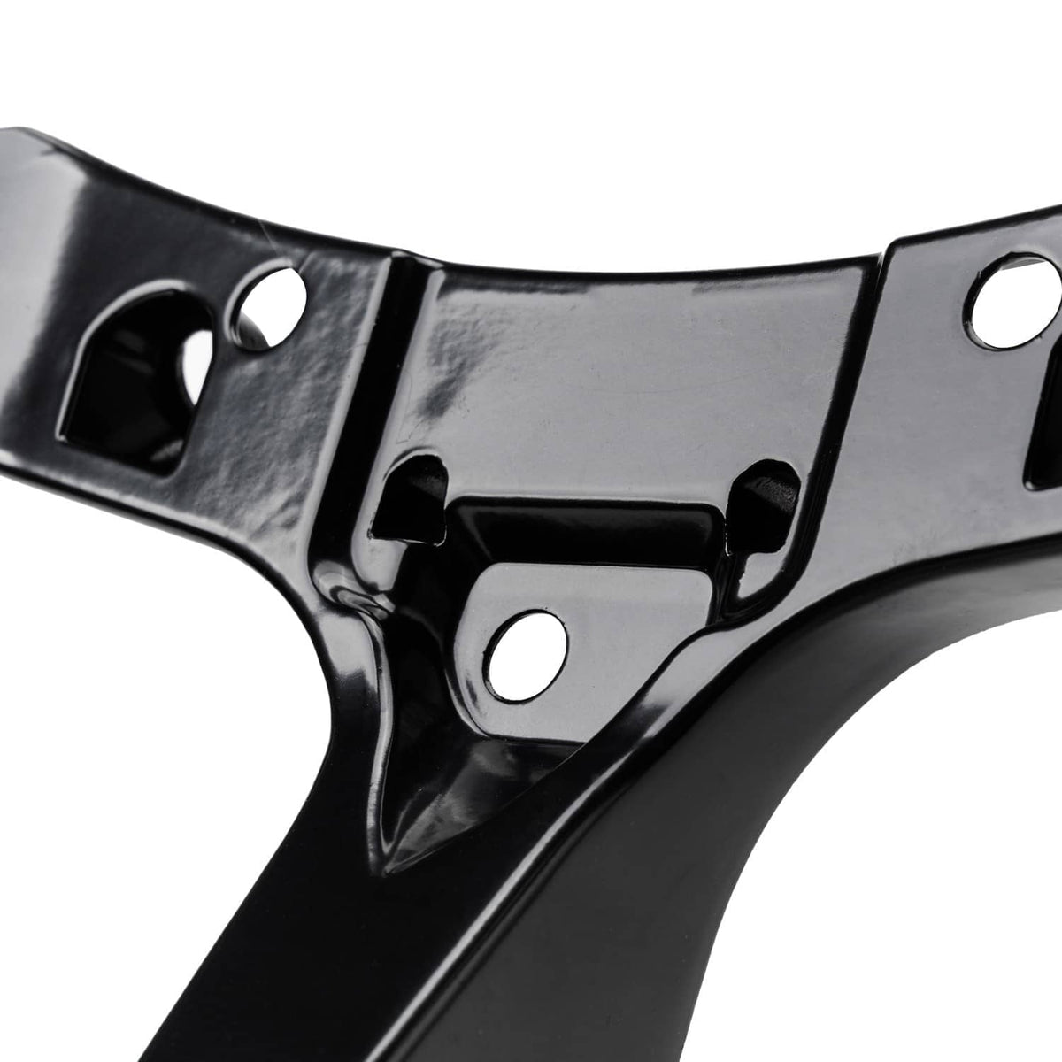 Close-up of black stamped stay bracket with circular holes and central mount