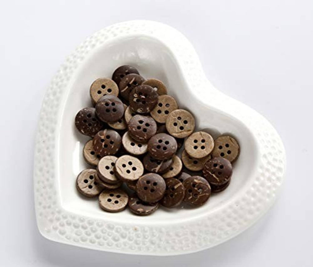 Round 4-hole coconut shell buttons in a white heart-shaped tray