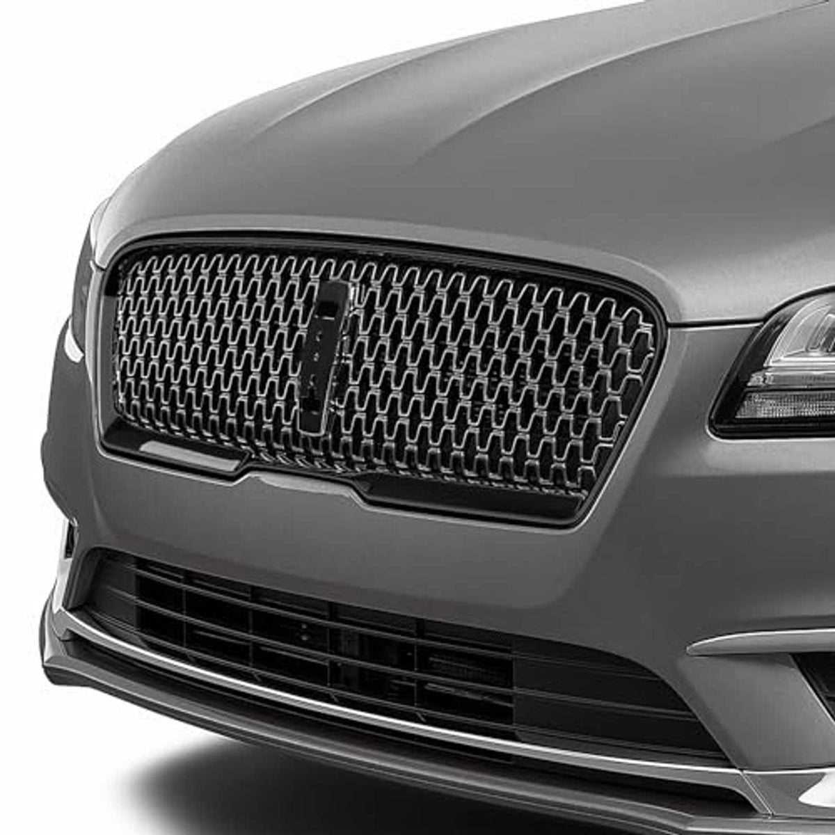 Front grille with black mesh insert and bumper trim on dark gray vehicle