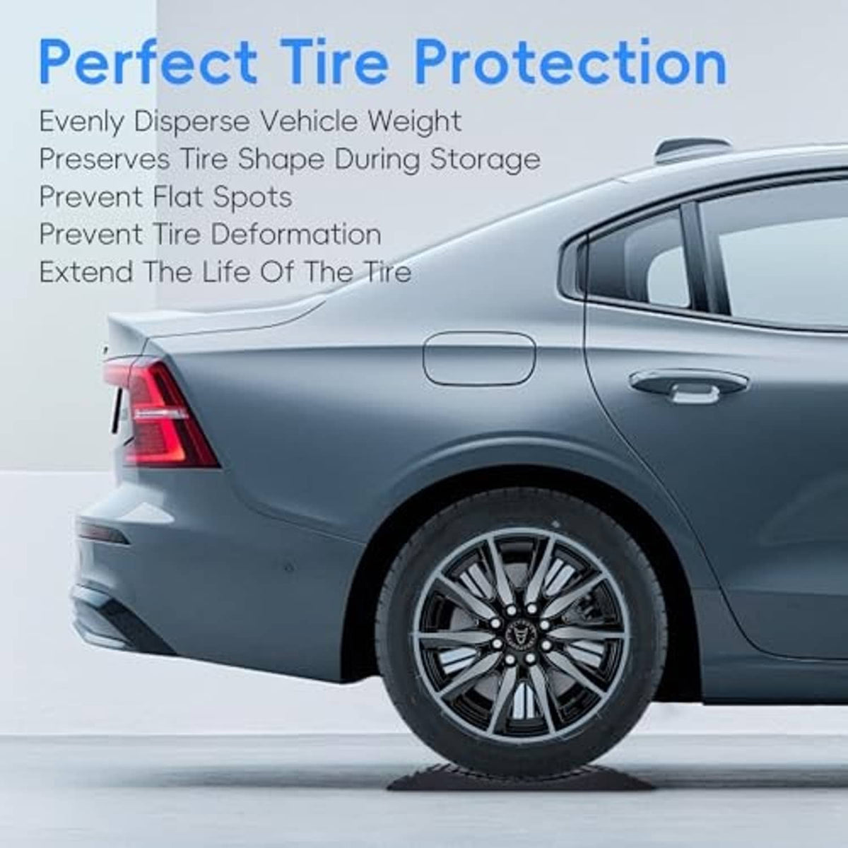 Rubber tire protection ramp under vehicle tire; textured anti-slip pad for stability.