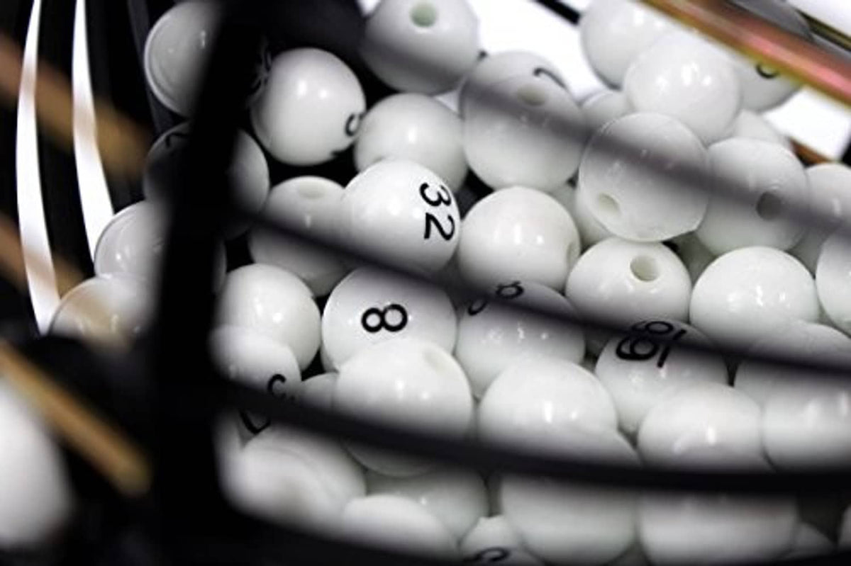 Bingo balls with raised numbers inside the cage