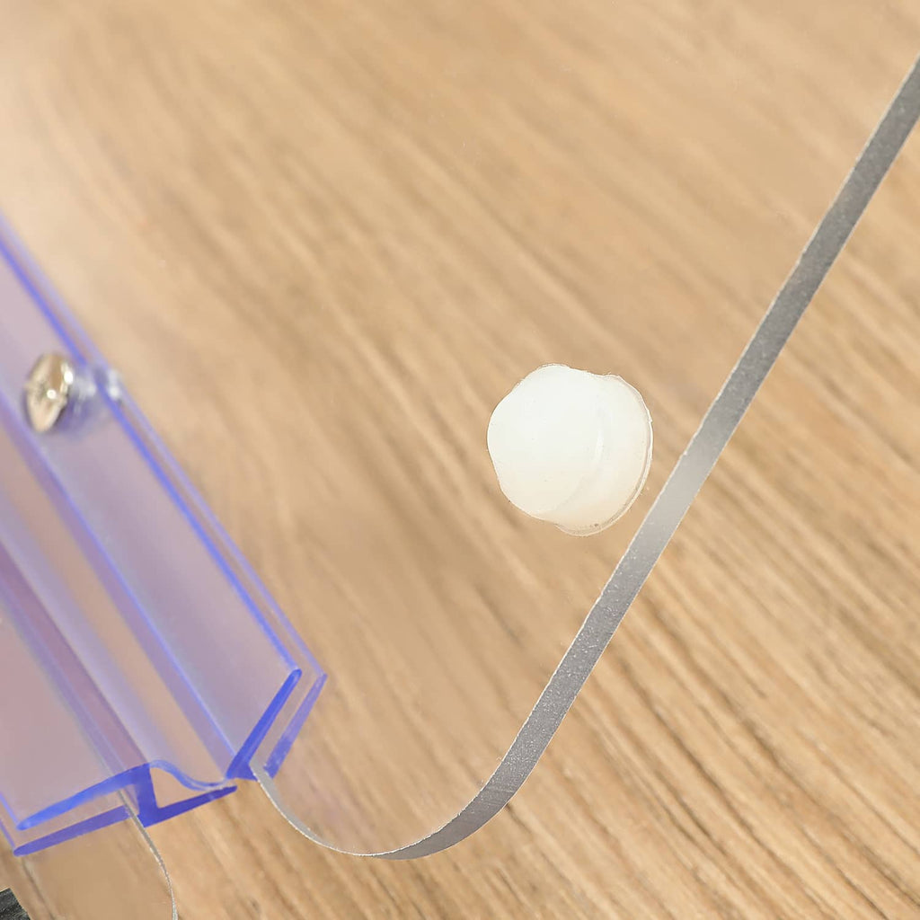 Clear windshield corner with blue frame and round fastener hole