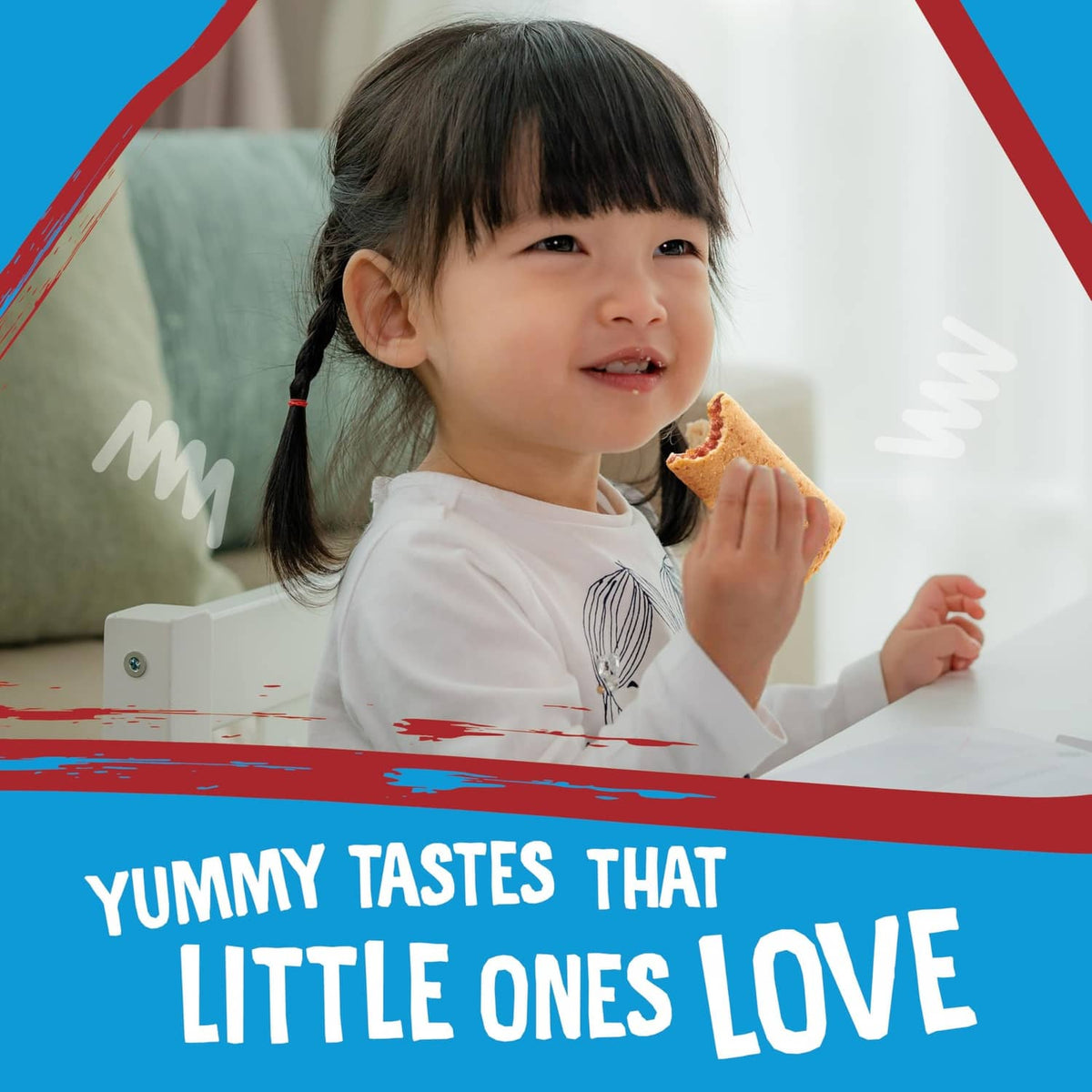 Child holding an apple-flavored snack bar, smiling in a seated indoor scene.