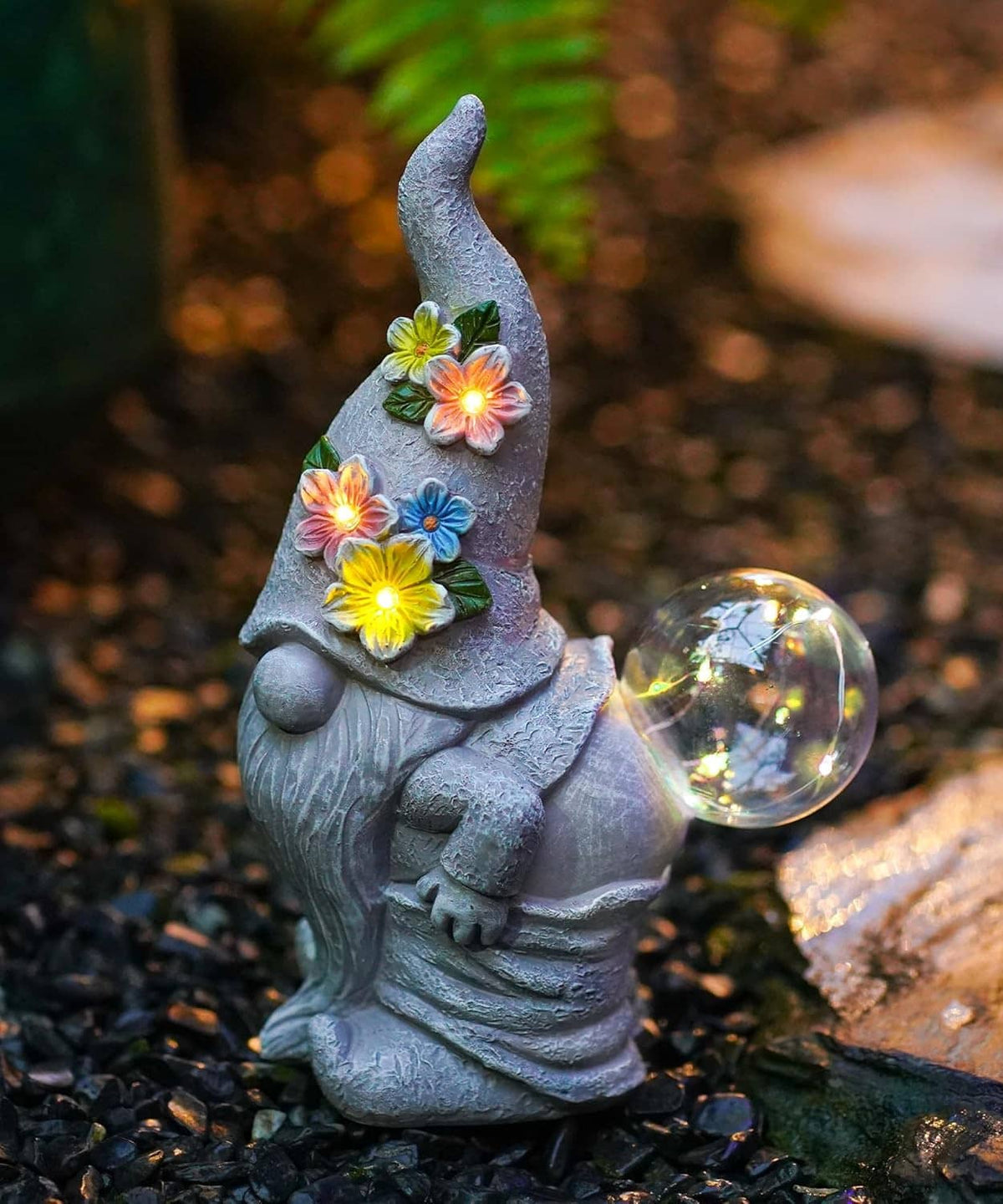 Solar garden gnome statue with glowing flower LEDs and clear bubble light, gray stone look