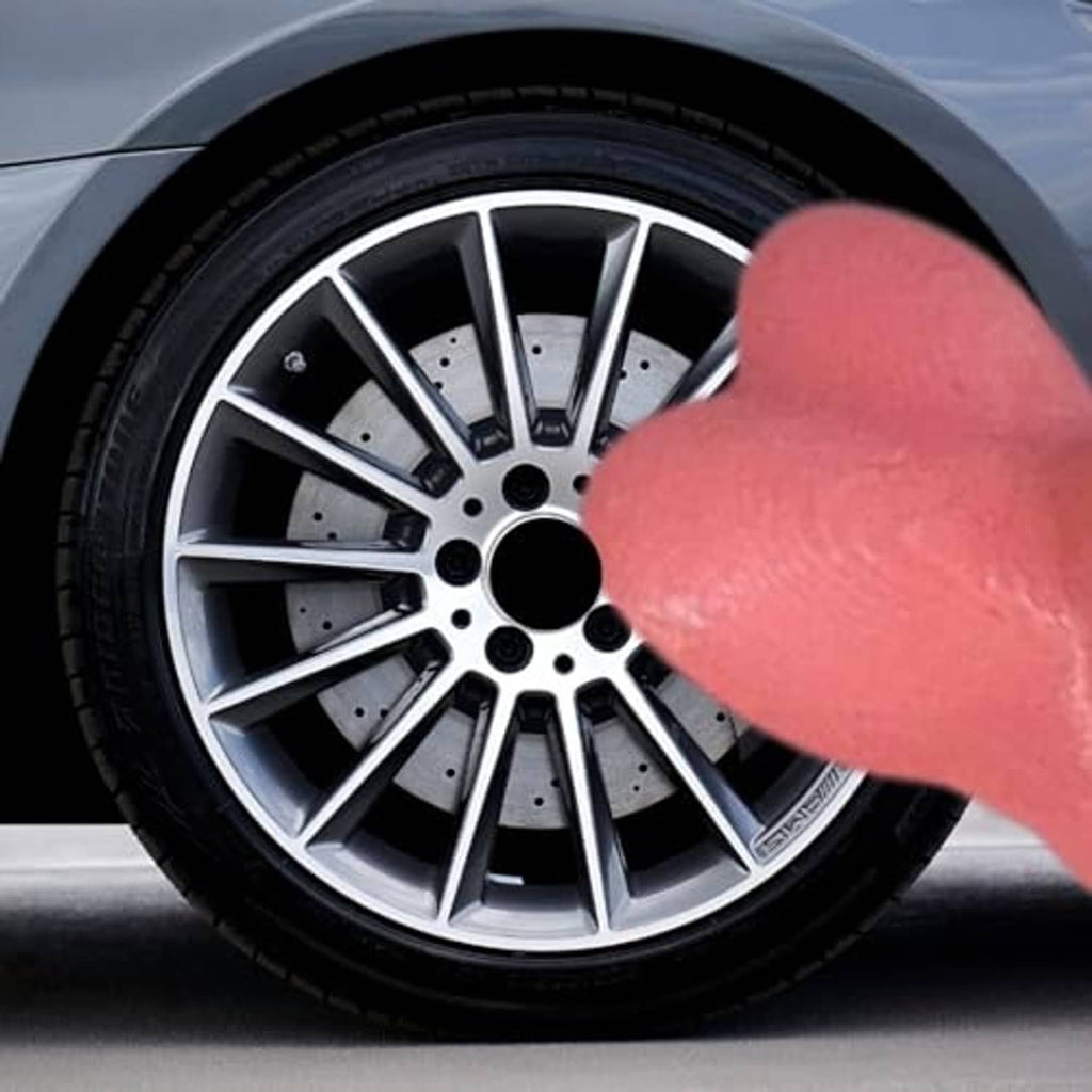 Pink novelty valve stem cap on front wheel rim, inserted into tire valve