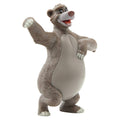 Painted bear toy figure, grey fur with white belly, one arm raised and smiling