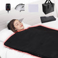 Portable infrared sauna heating blanket, black with red trim, laid on a bed