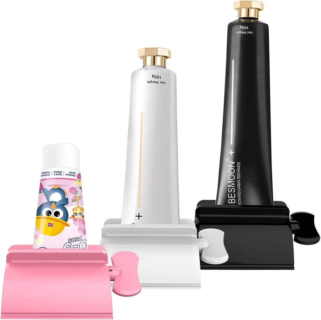 Toothpaste tube squeezer set with white and black holders plus pink base for tubes