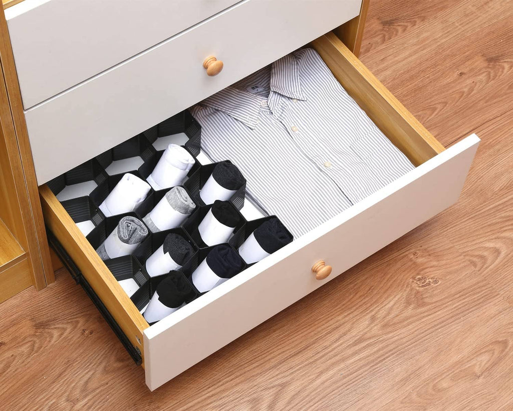 Black honeycomb drawer organizer divider holding socks in separate cubby cells