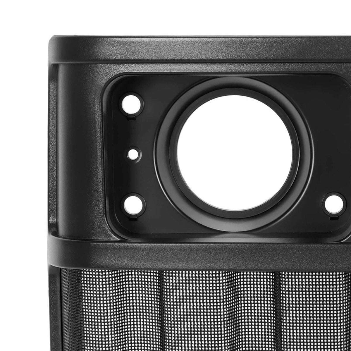 Close-up of front grille headlight opening in black housing with mesh grille panel below