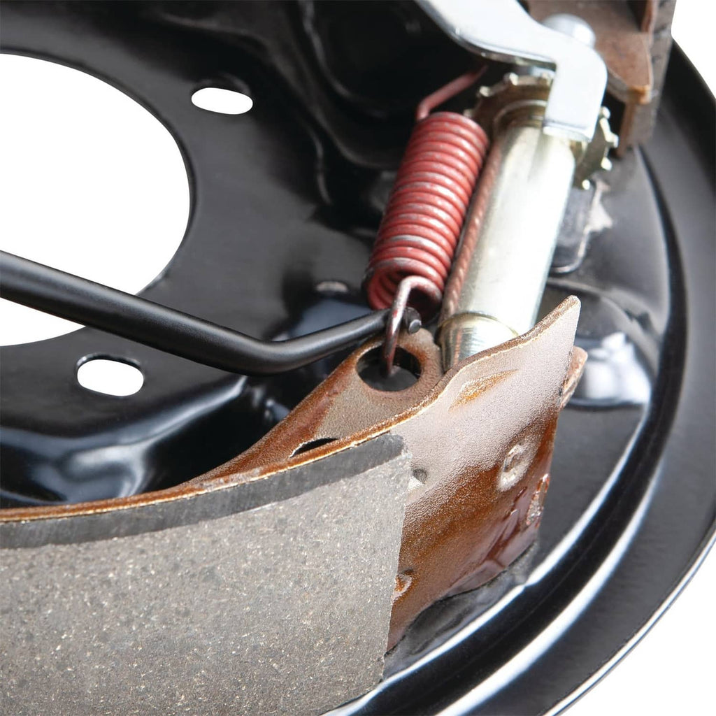 Hook tool angled into brake area over spring and mounting bracket