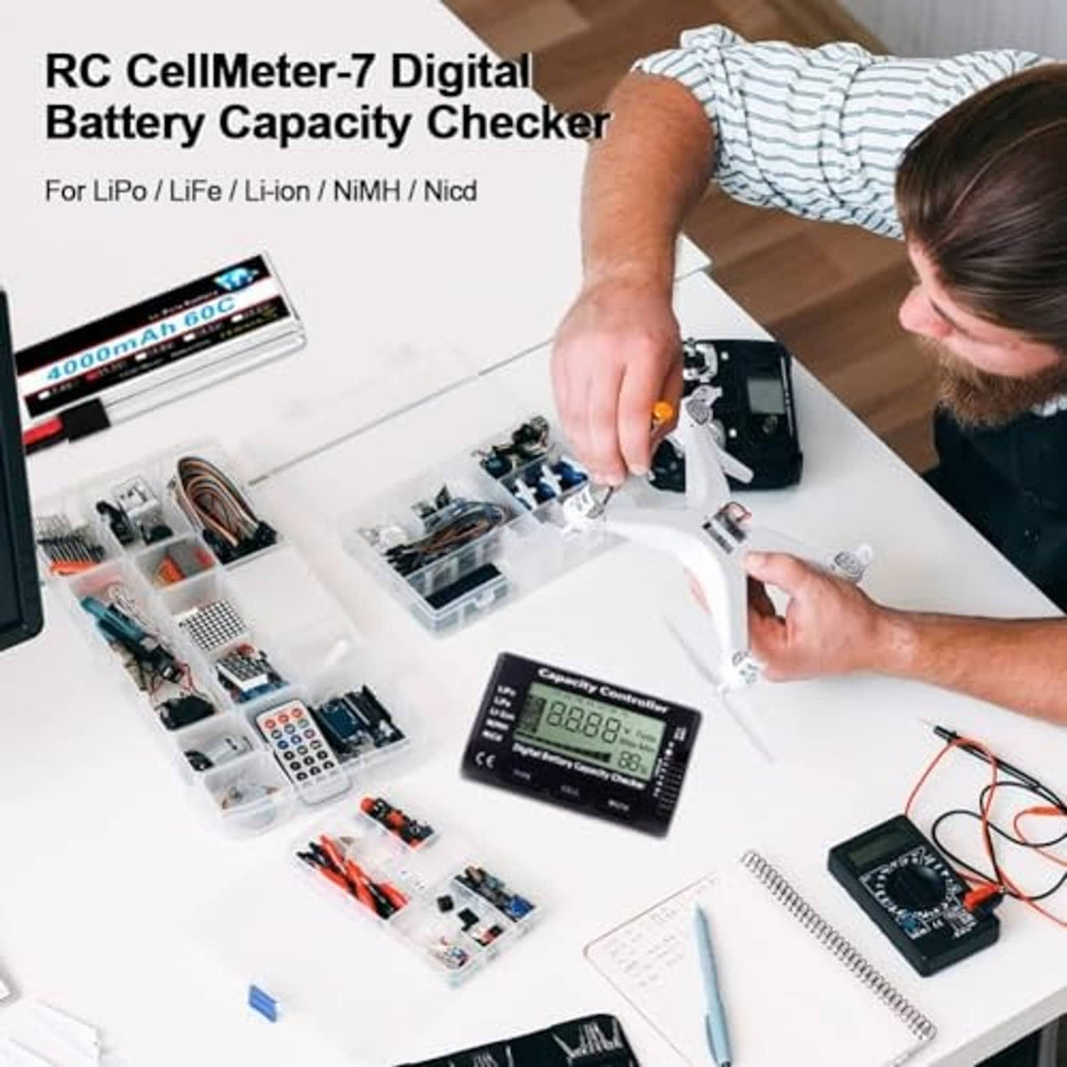 Black RC battery capacity checker with attached leads and small electronics components