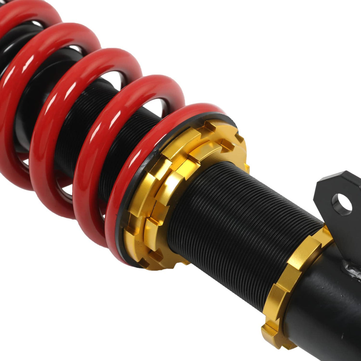 Close-up coilover strut: red and black springs with black threaded body and gold adjuster ring