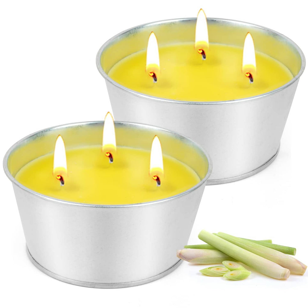 Pair of large citronella candles in silver tins with yellow wax and flames