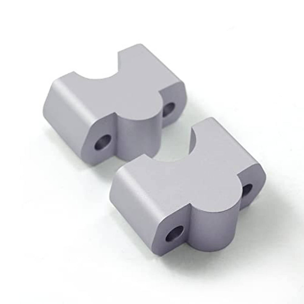 Silver CNC aluminum handlebar riser replacement brackets, angled view showing hole cutouts