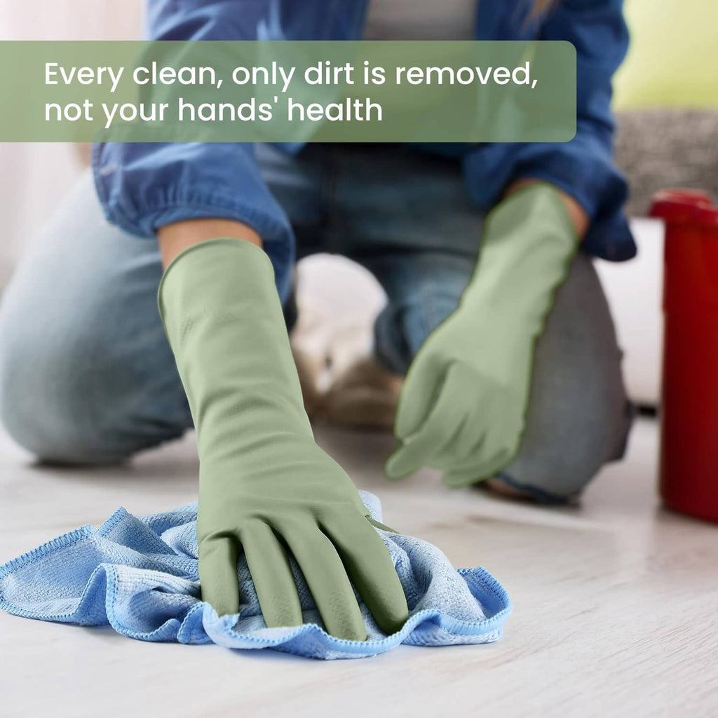 Green and blue rubber dishwashing gloves with textured palms wiping a cloth