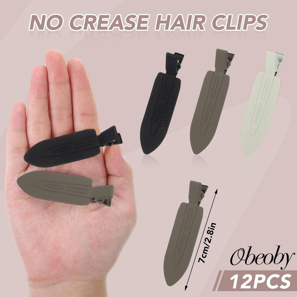 No-bend hair clips held in hand: black, gray, and white barrettes in a set