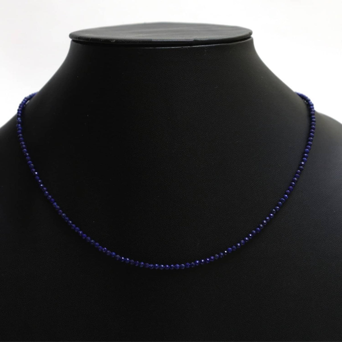 Lapis lazuli beaded necklace with dark blue beads, shown on a mannequin neck