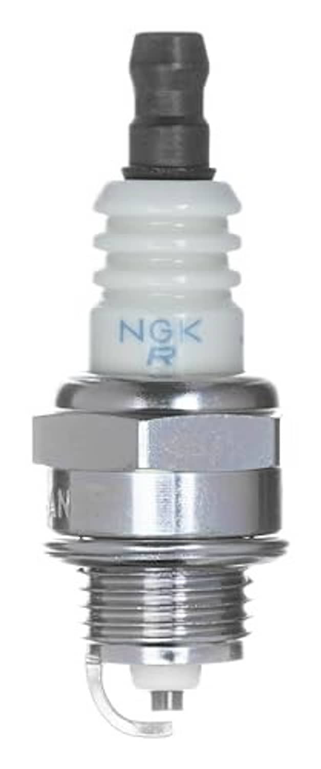 NGK spark plug close-up with white insulator and metal threaded base