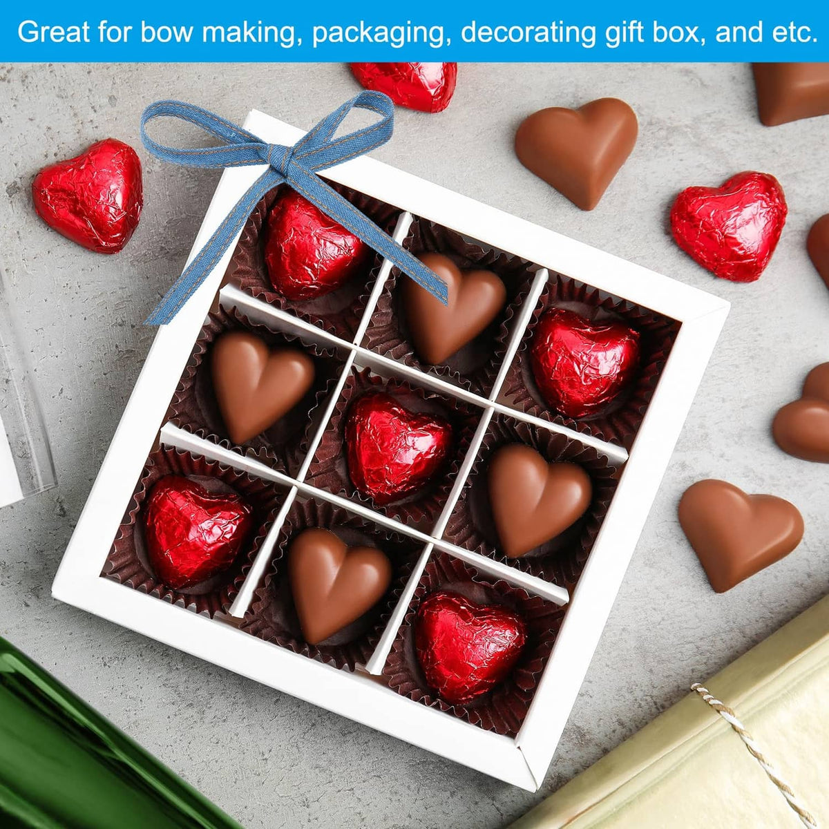 Dark blue denim ribbon tied on a gift box with assorted chocolate hearts
