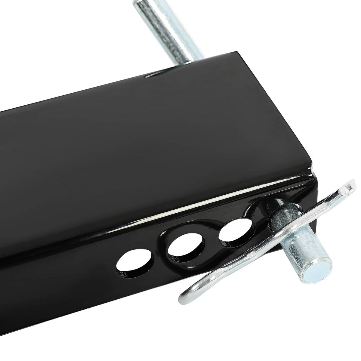 Close-up of black mounting plate with round holes and galvanized bolt hardware