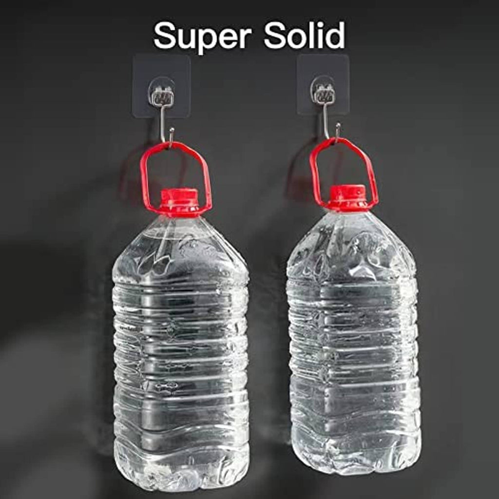 Large wall hooks holding two capped water bottles with red looped cord