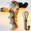 Archery bow thumb release with black trigger and Realtree-style camo handle, lanyard included