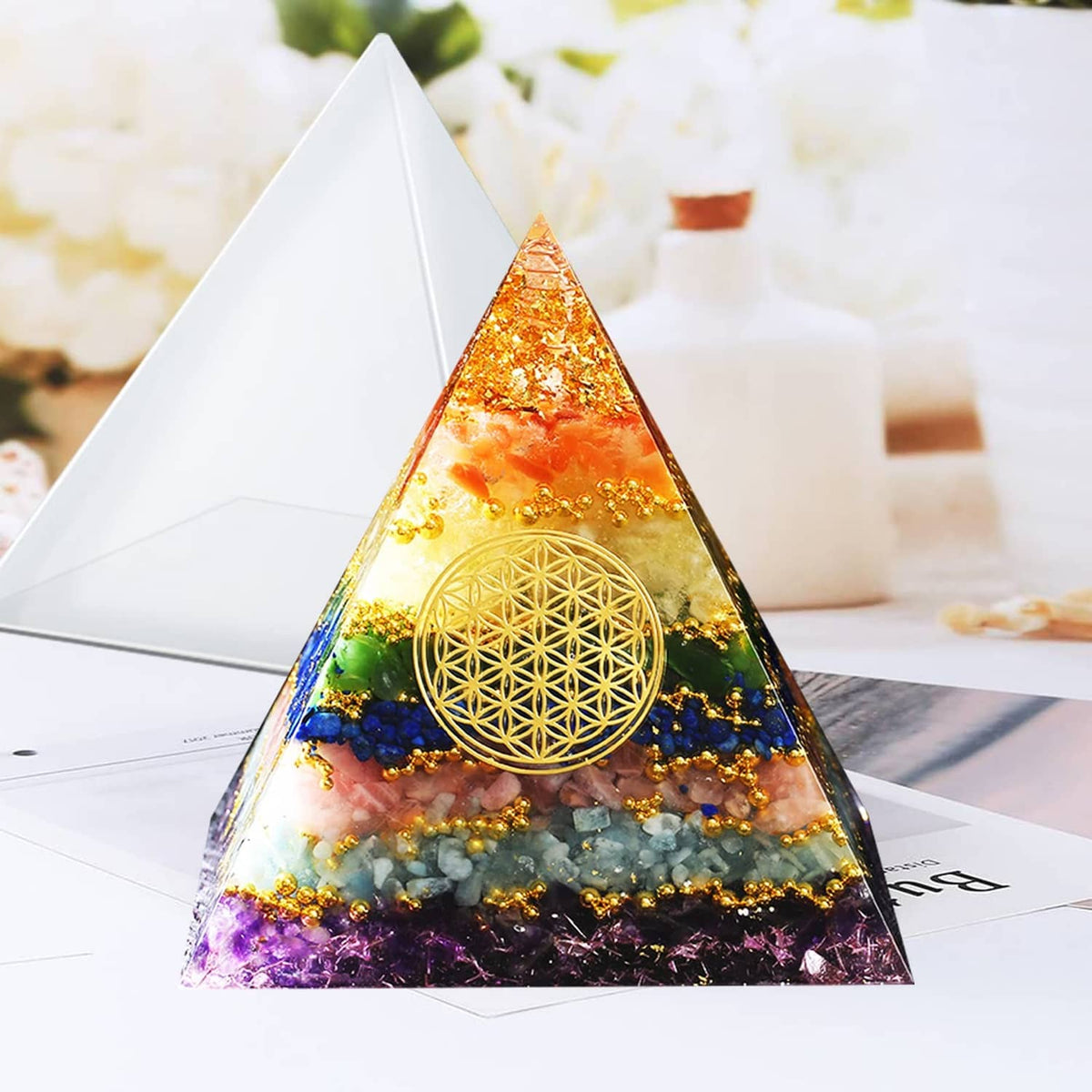 Gold-pattern pyramid resin casting with colorful swirls, set in a clear mold shape