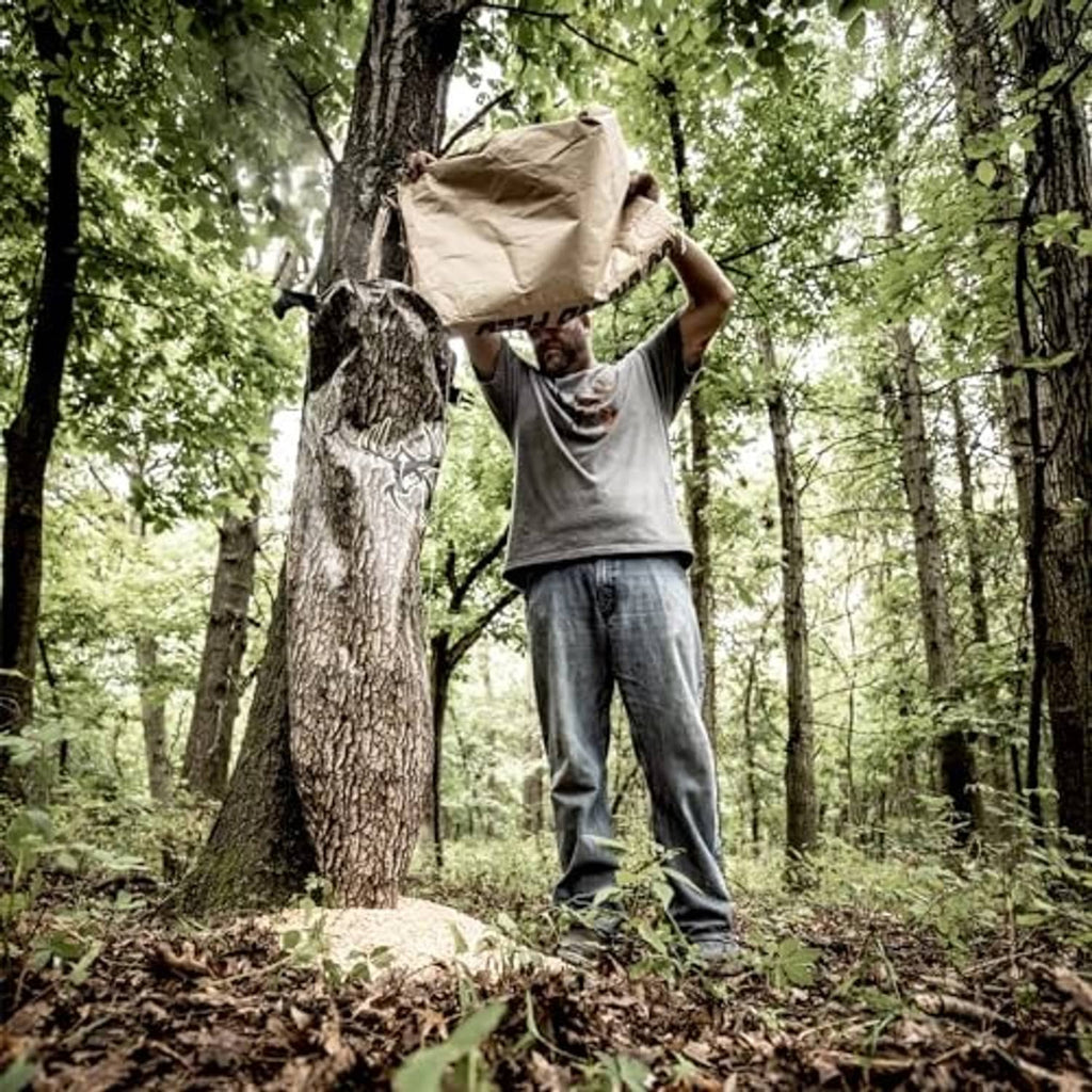 Camo gravity feeder bag carried in forest, tree-bark print