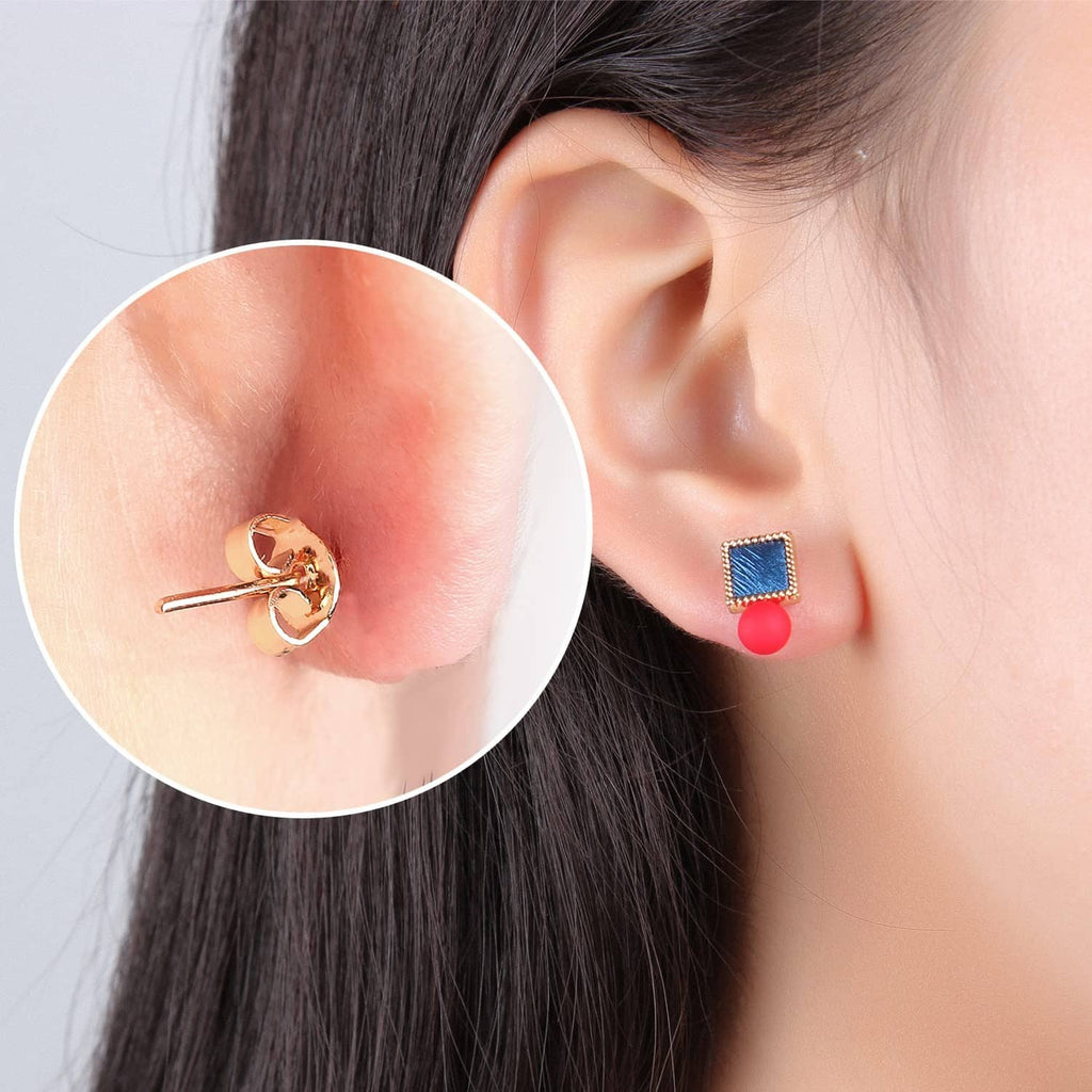 Gold butterfly earring back holding a stud earring on ear