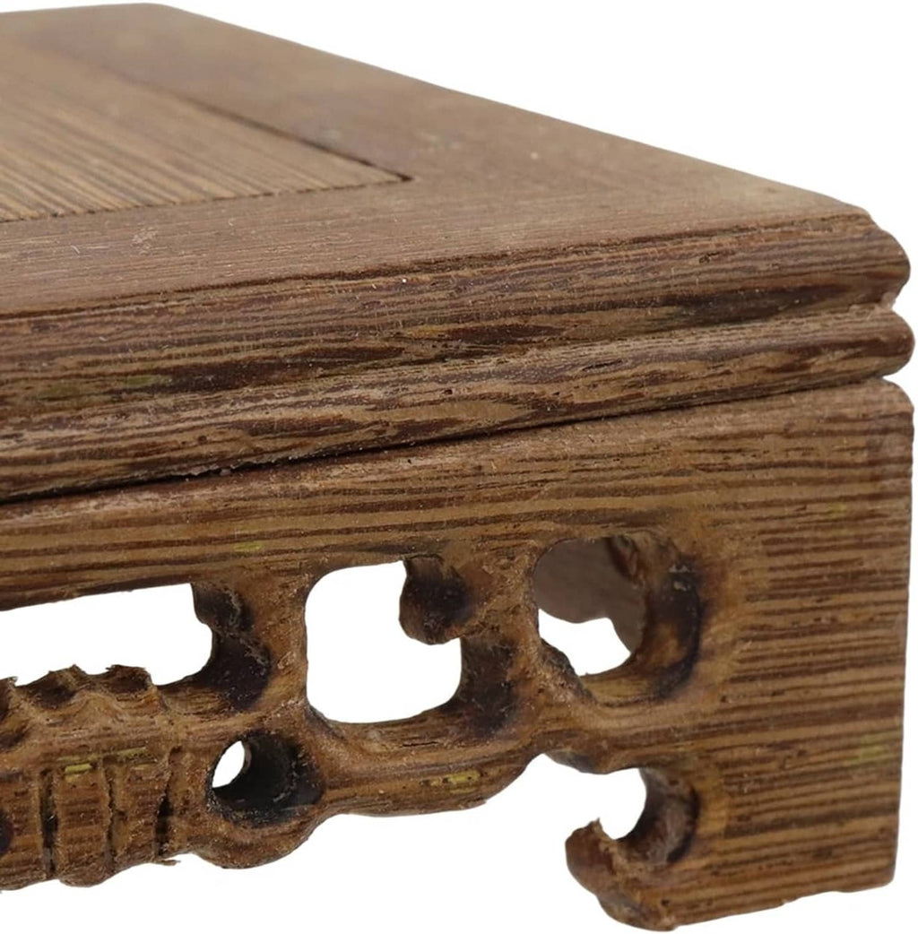 Wooden display stand base close-up of carved side edge and row of oval cutouts