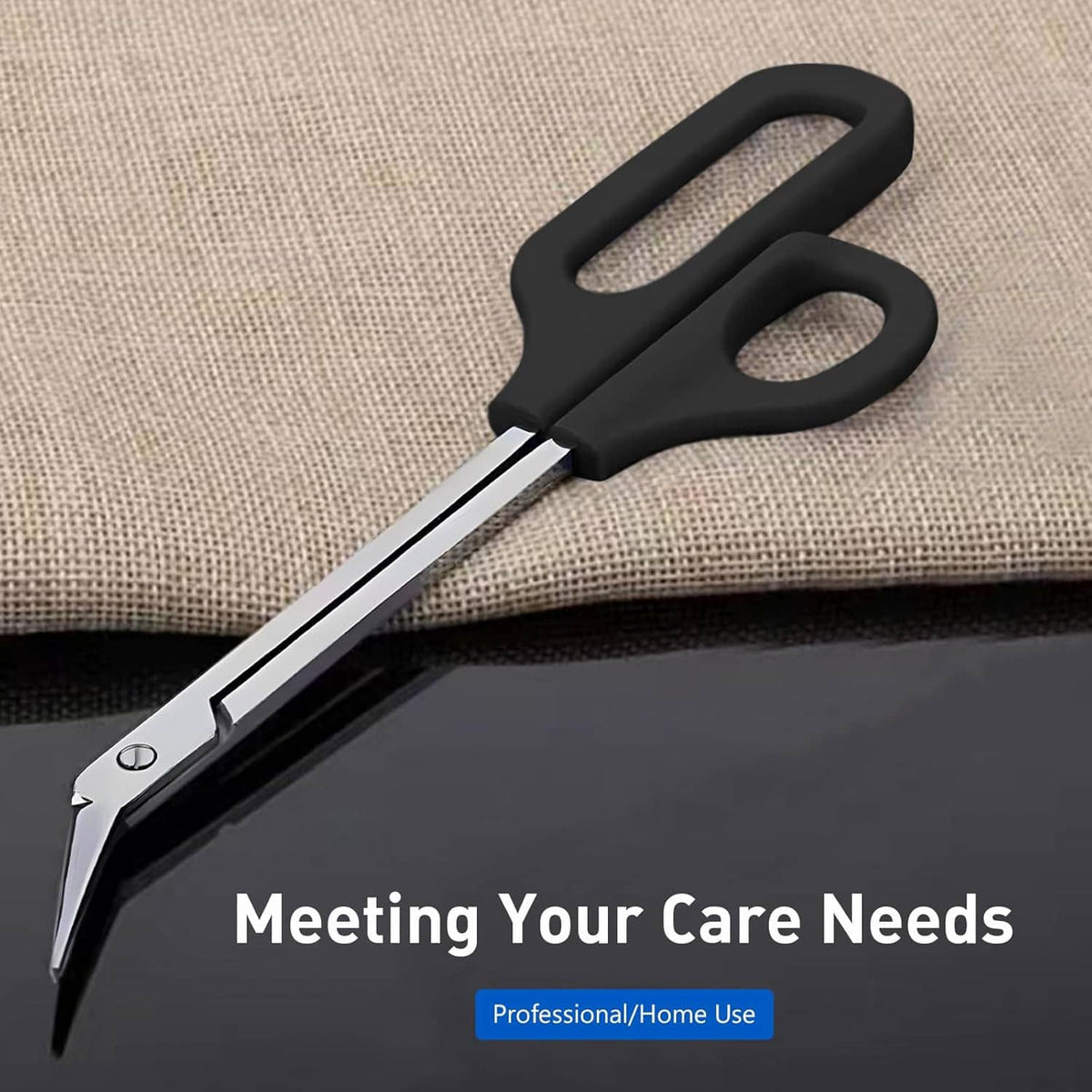 Black long-handled toenail scissors with silver blades, close-up on fabric
