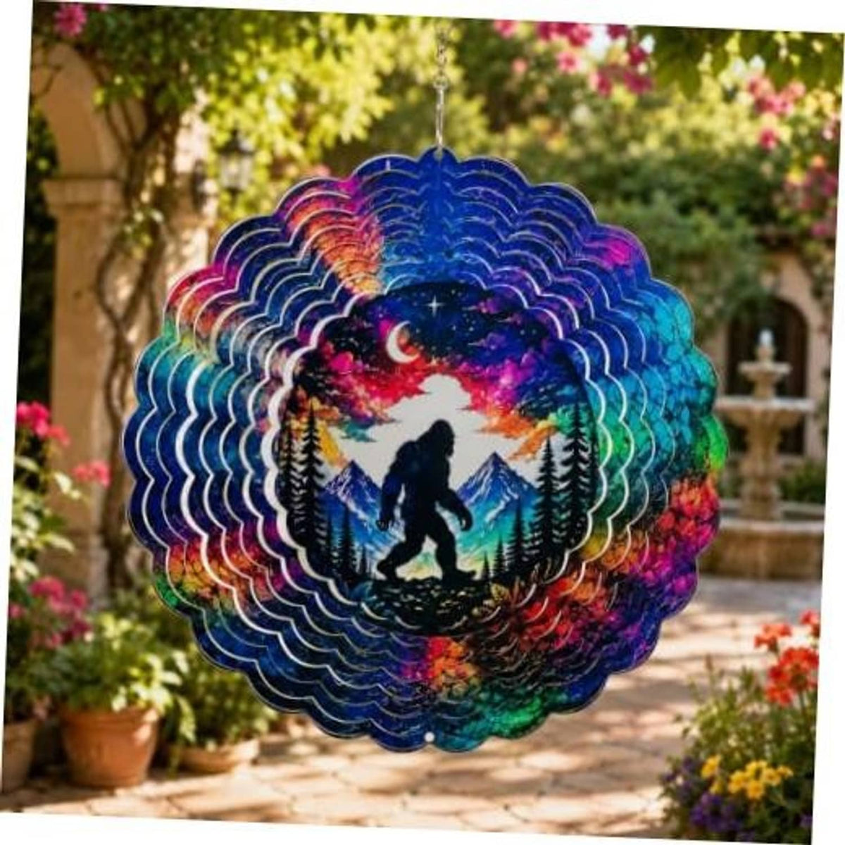 Colorful hanging wind spinner with Bigfoot silhouette, moon, and pine trees sky design