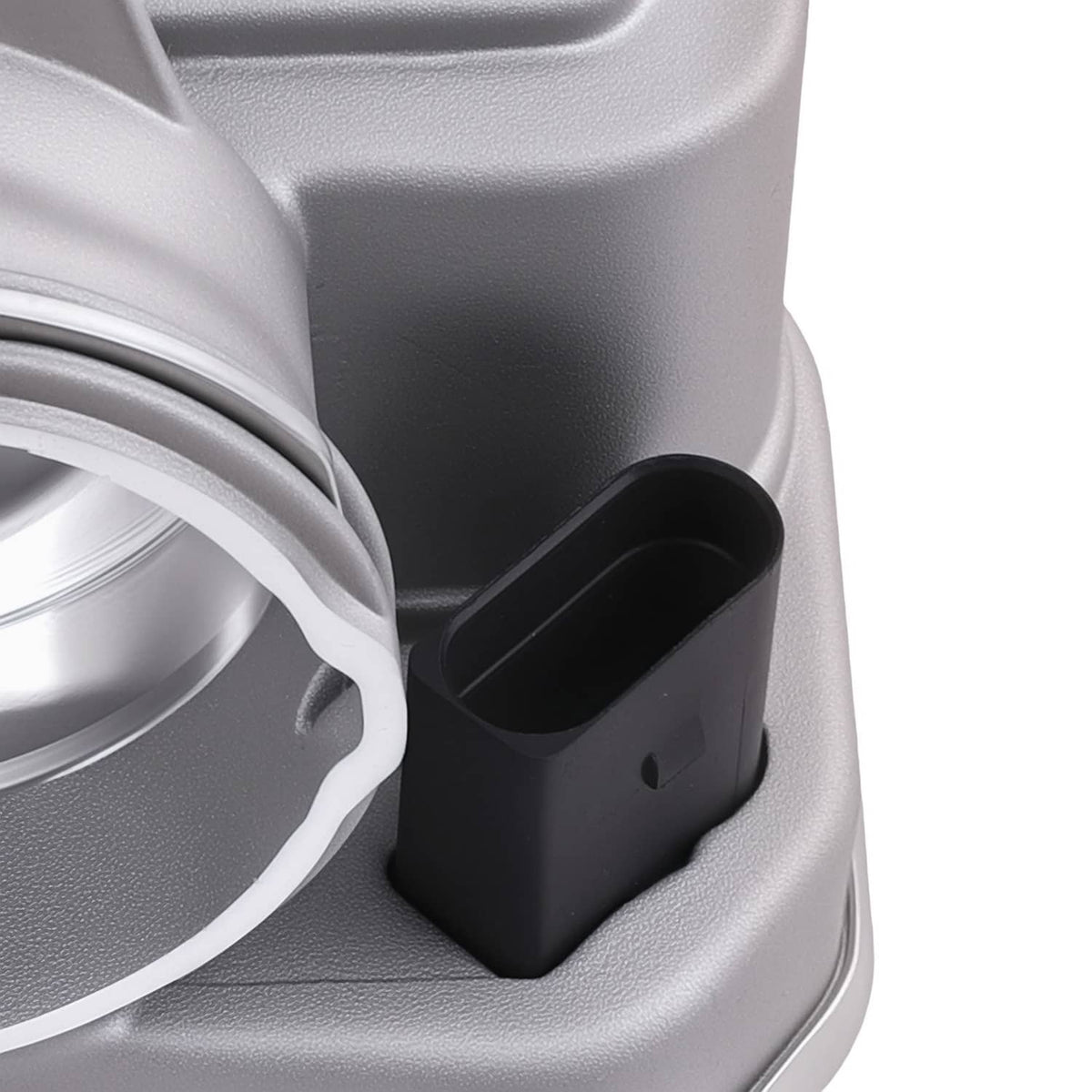 Throttle body intake opening with black tube and silver mounting housing
