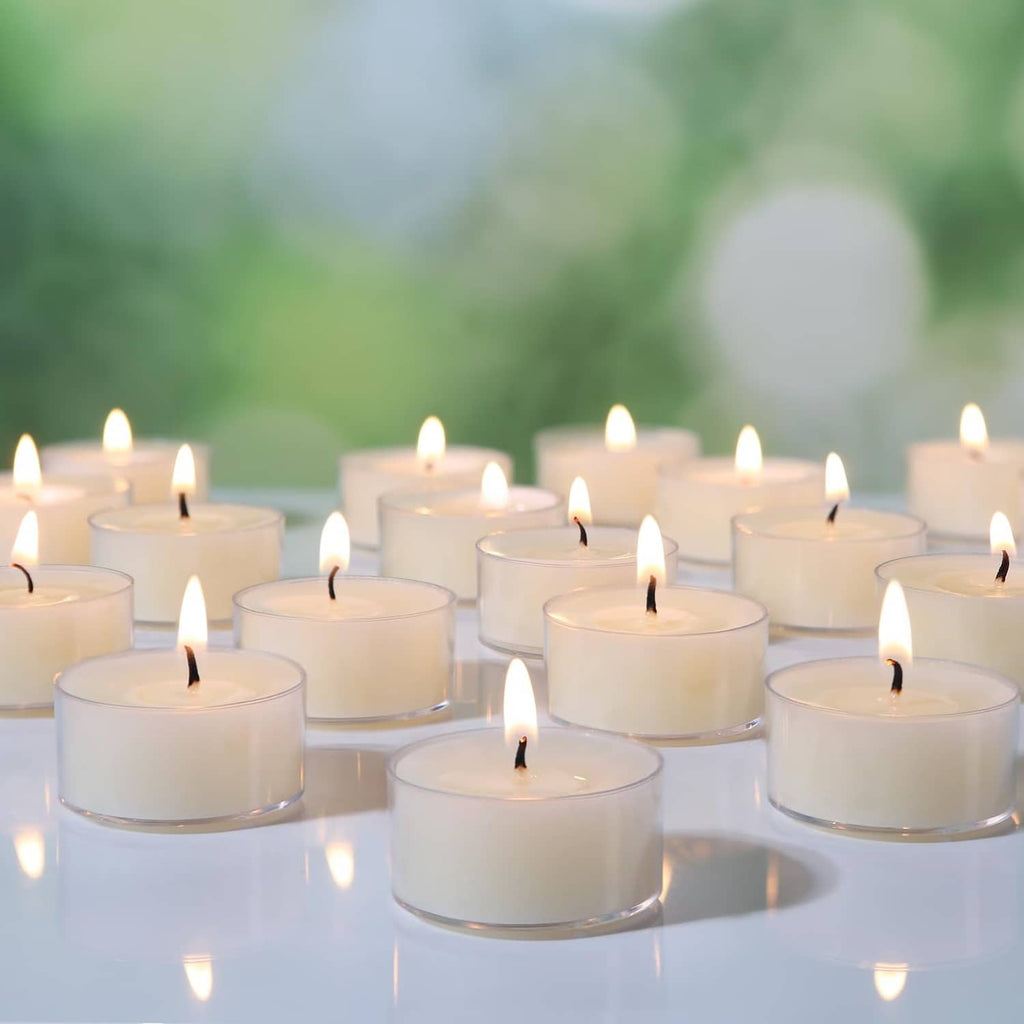Cream beeswax tea light candles with flames, arranged in rows