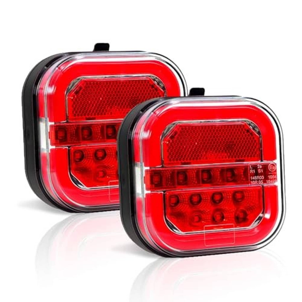 Pair of red square LED trailer lights with clear lens and black rubber edging